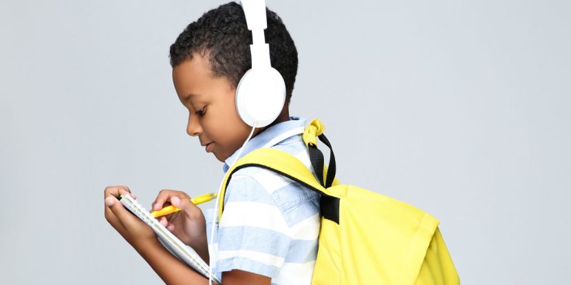 kid with headphones and yellow backpack